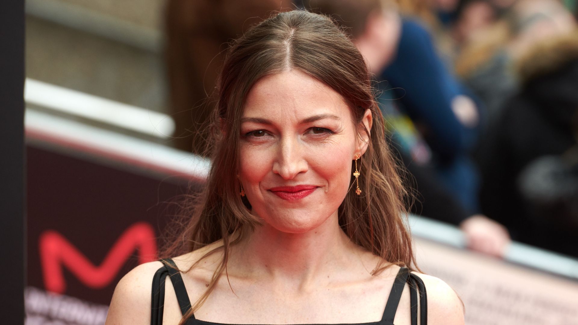 close-up of woman with brown hair smiling for photo