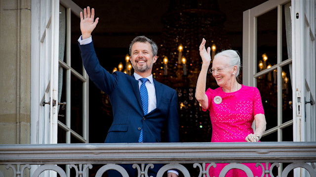 Crown Prince Frederik and Queen Margrethe wave from balcont