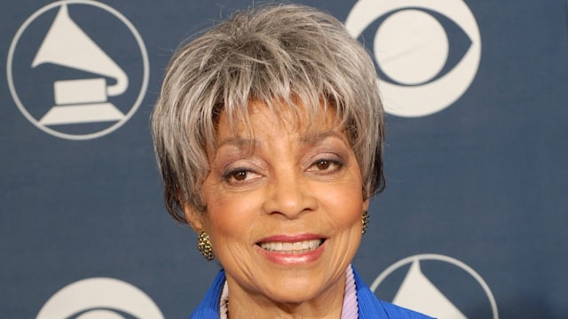 Ruby Dee wearing blue suit holding award 