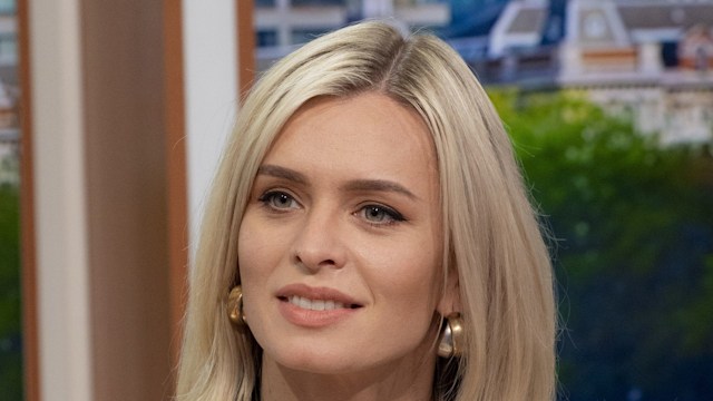 nadiya bychkova on sofa in white suit 