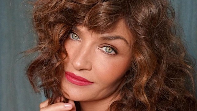 Helena Christensen wearing red dress and sporting curly hair on Instagram