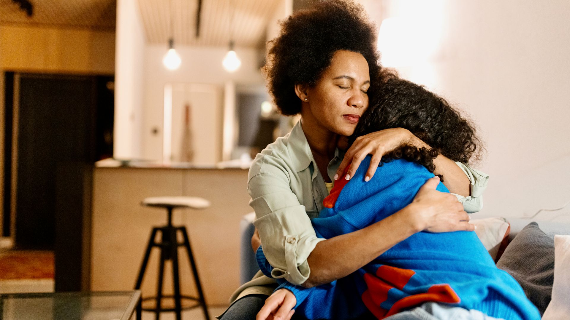 Mother and son hugging at home