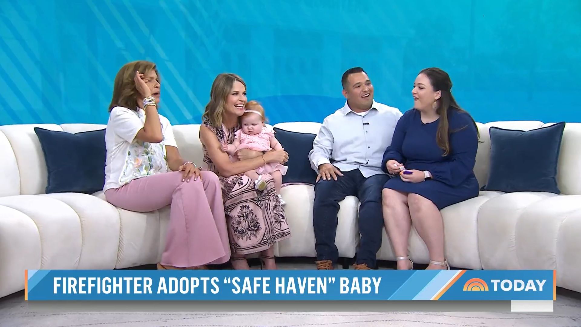 Savannah and Hoda sat on a couch alongside Zoey's parents, Savannah is holding Zoey and Hoda is wiping away a tear from her eye