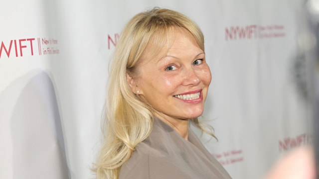 photo of pamela anderson smiling at red carpet event