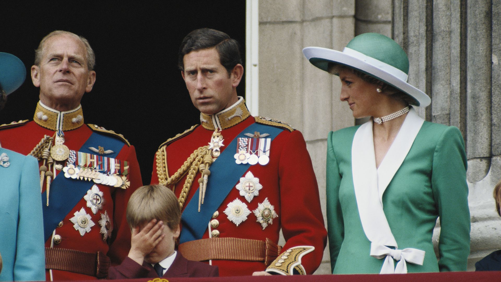 Prince William covering his face with Prince Philip, Prince Charles and Princess Diana standing behind him