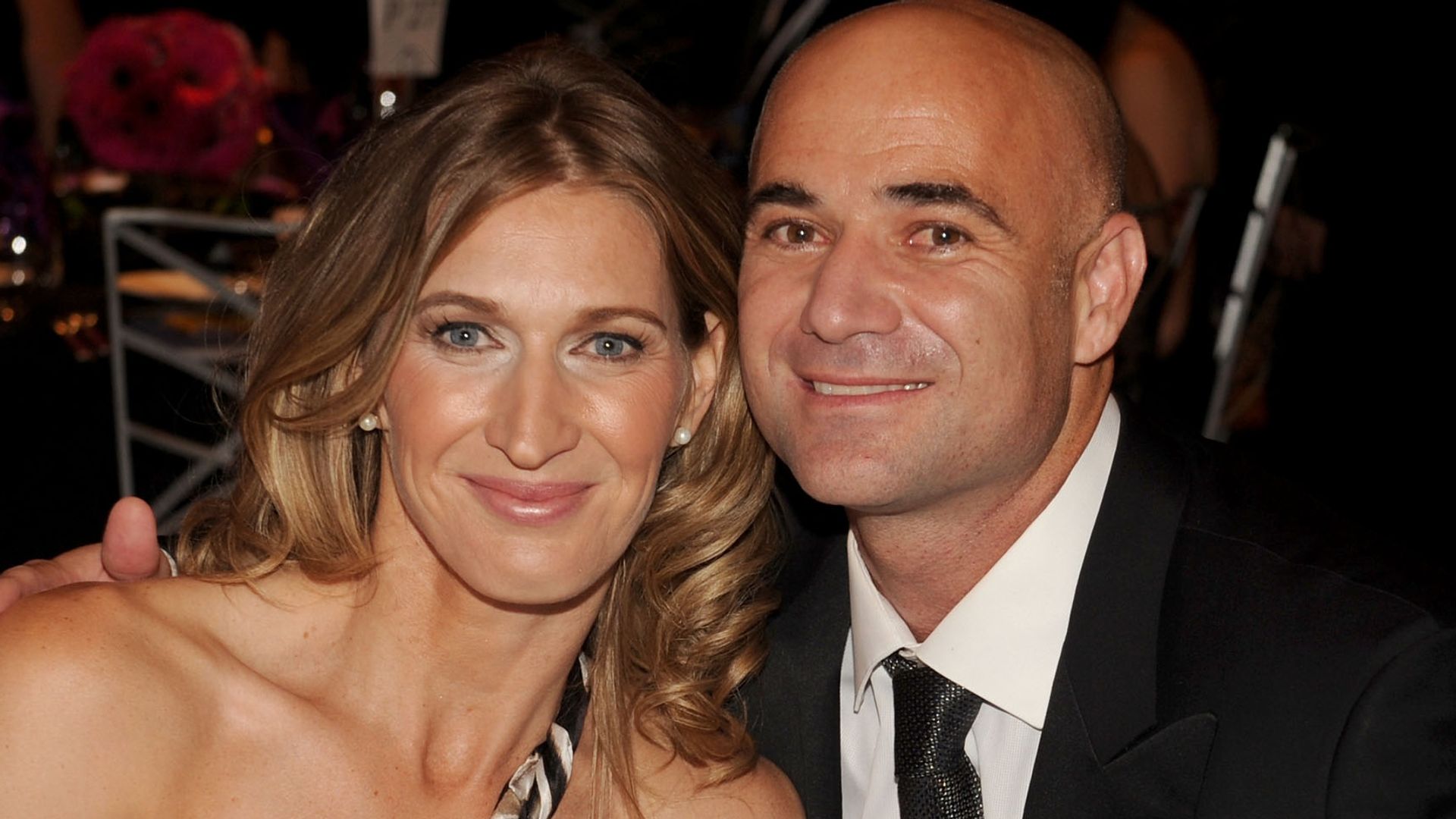 Andre Agassi in a suit and Stefanie in a one-shoulder dress at dinner