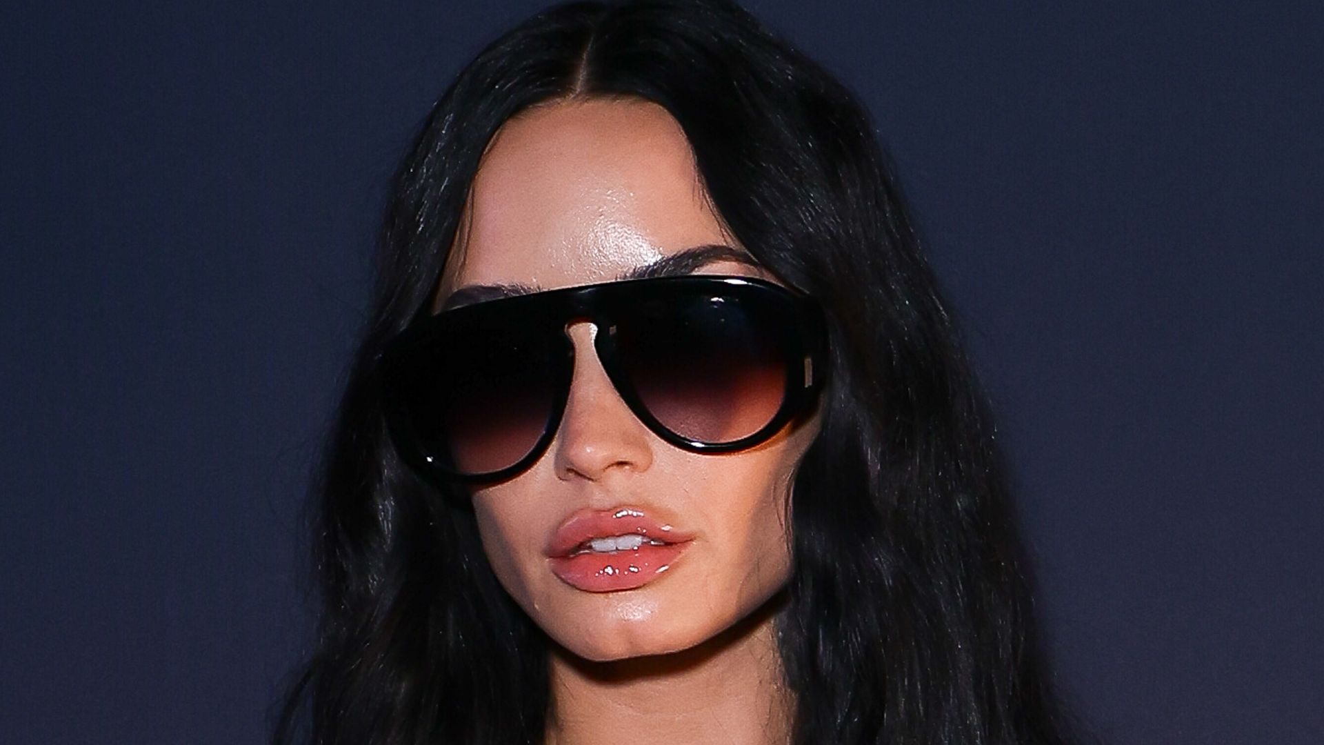 photo of demi lovato wearing sunglasses and lace bralette