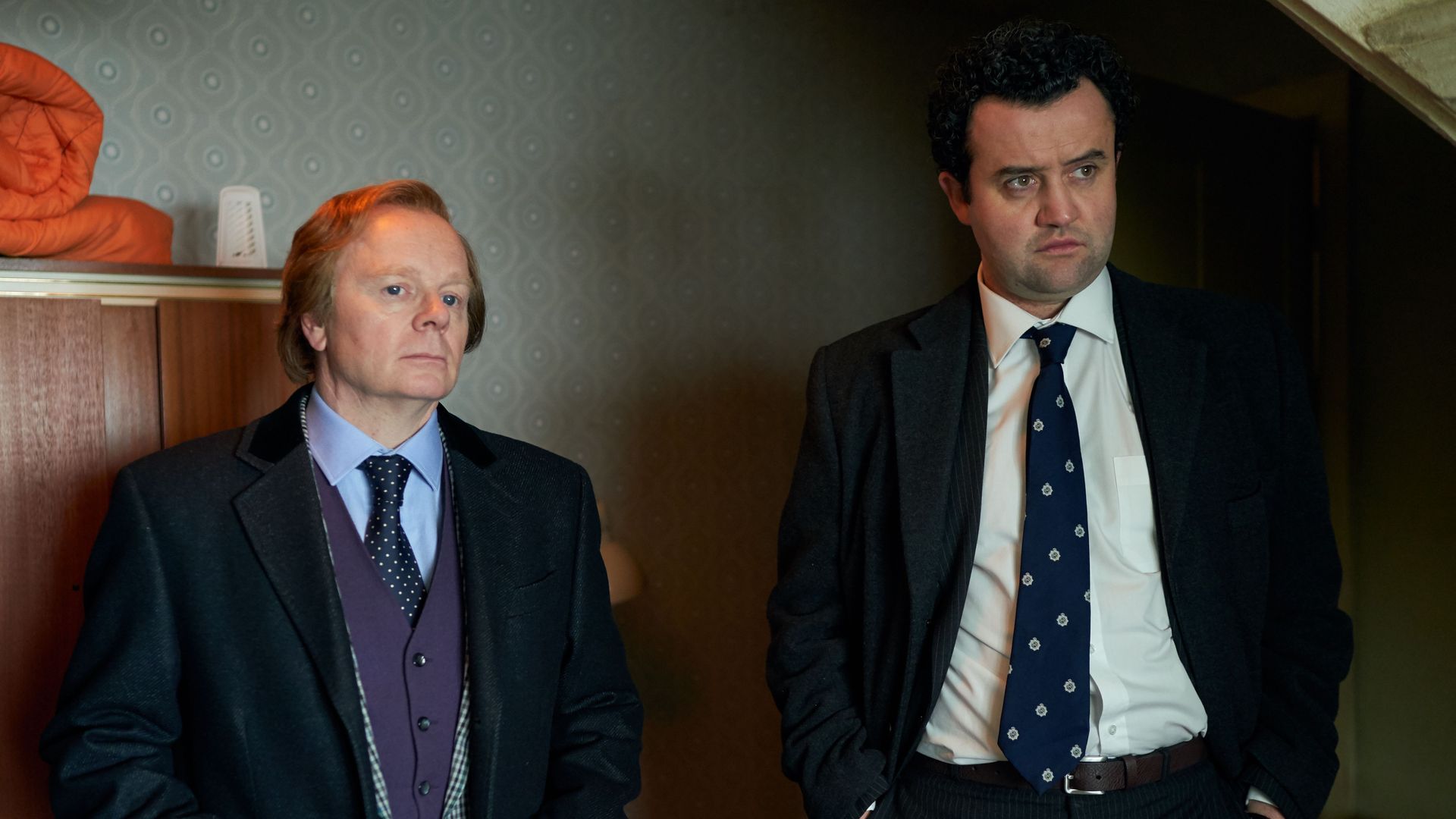 two me in suits standing in room