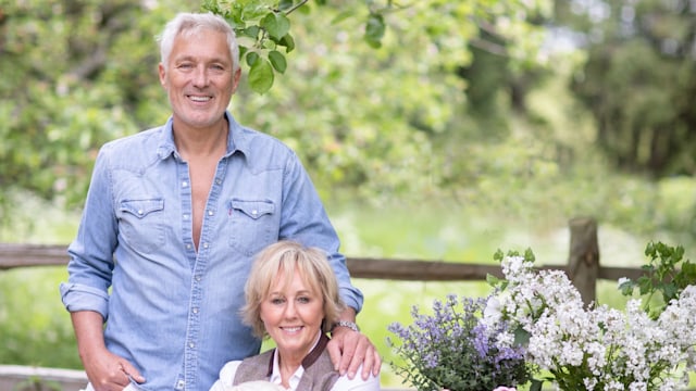 Shirlie Kemp poses with their dog and husband Martin as they sit in her garden