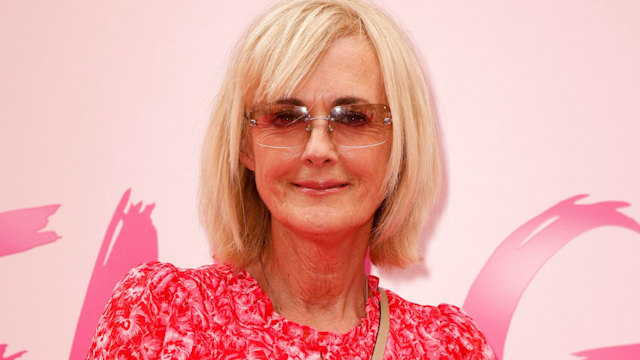 Jane Moore in a pink dress and sunglasses