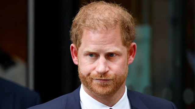 Prince Harry looking serious in suit and tie
