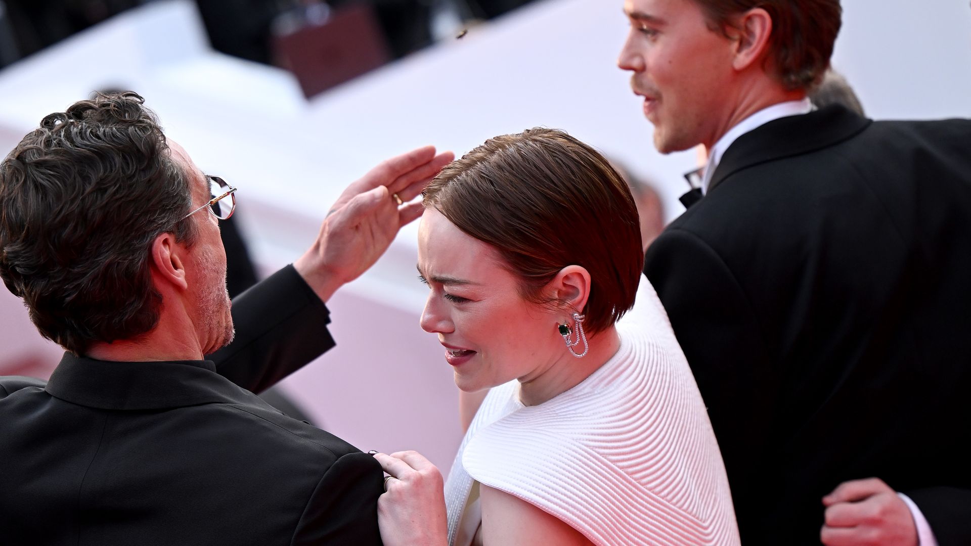 Pedro Pascal swatting a bee away from Emma Stone