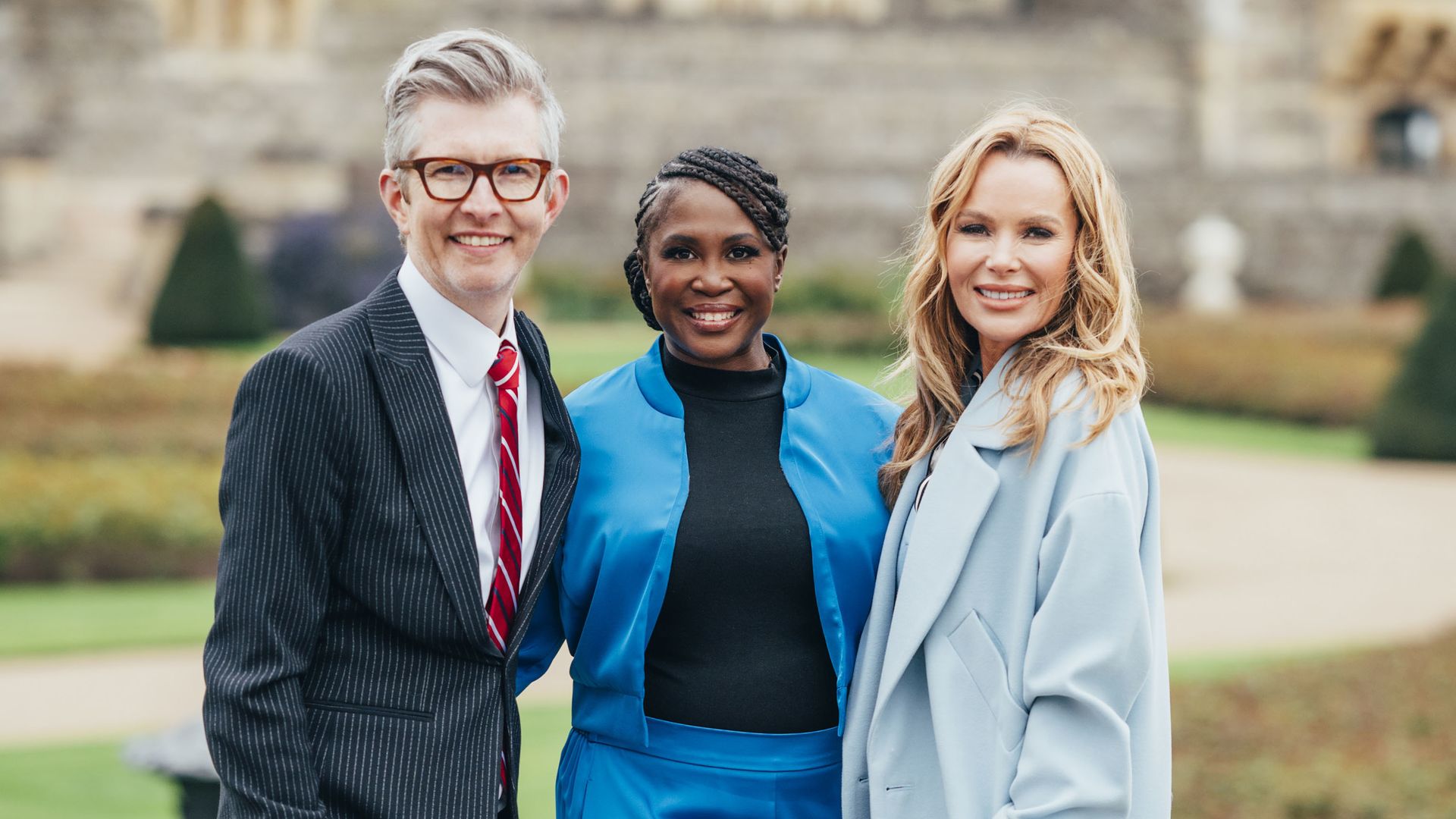 Gareth Malone, Motsi Mabuse and Amanda Holden smiling in the grounds of Windsor Castle