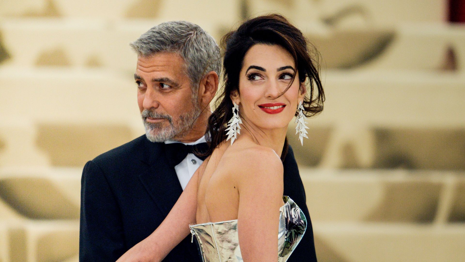 Actor George Clooney and lawyer Amal Clooney enter the Heavenly Bodies: Fashion & The Catholic Imagination Costume Institute Gala at The Metropolitan Museum on May 07, 2018 in New York City