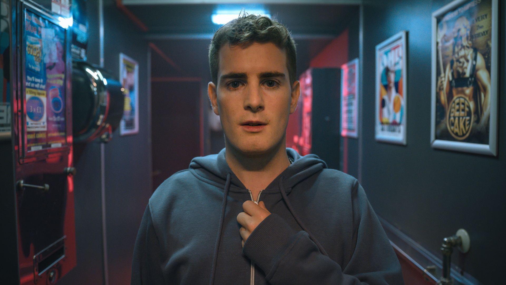 person in hoodie standing in club hall