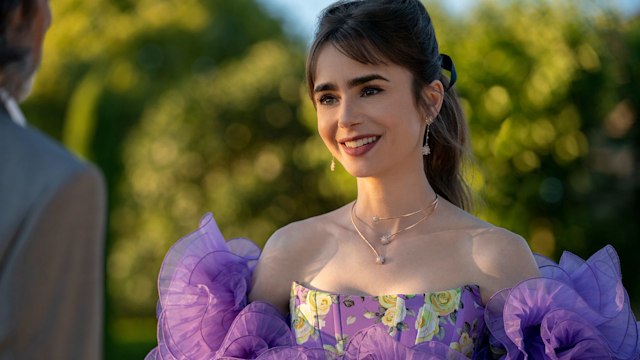 Emily Cooper (Lilly Collins) wearing a purple dress. 