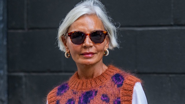 Grece Ghanem wearing leopard print jumper beige pleated shirt, white shirt, black bag, boots outside Cos on September 13, 2022 in New York City.