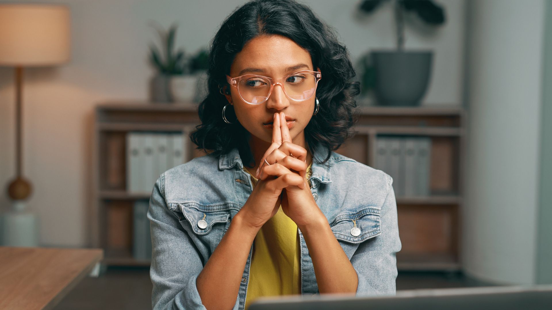 skeptical woman wearing denim jacket looking concerned and worried