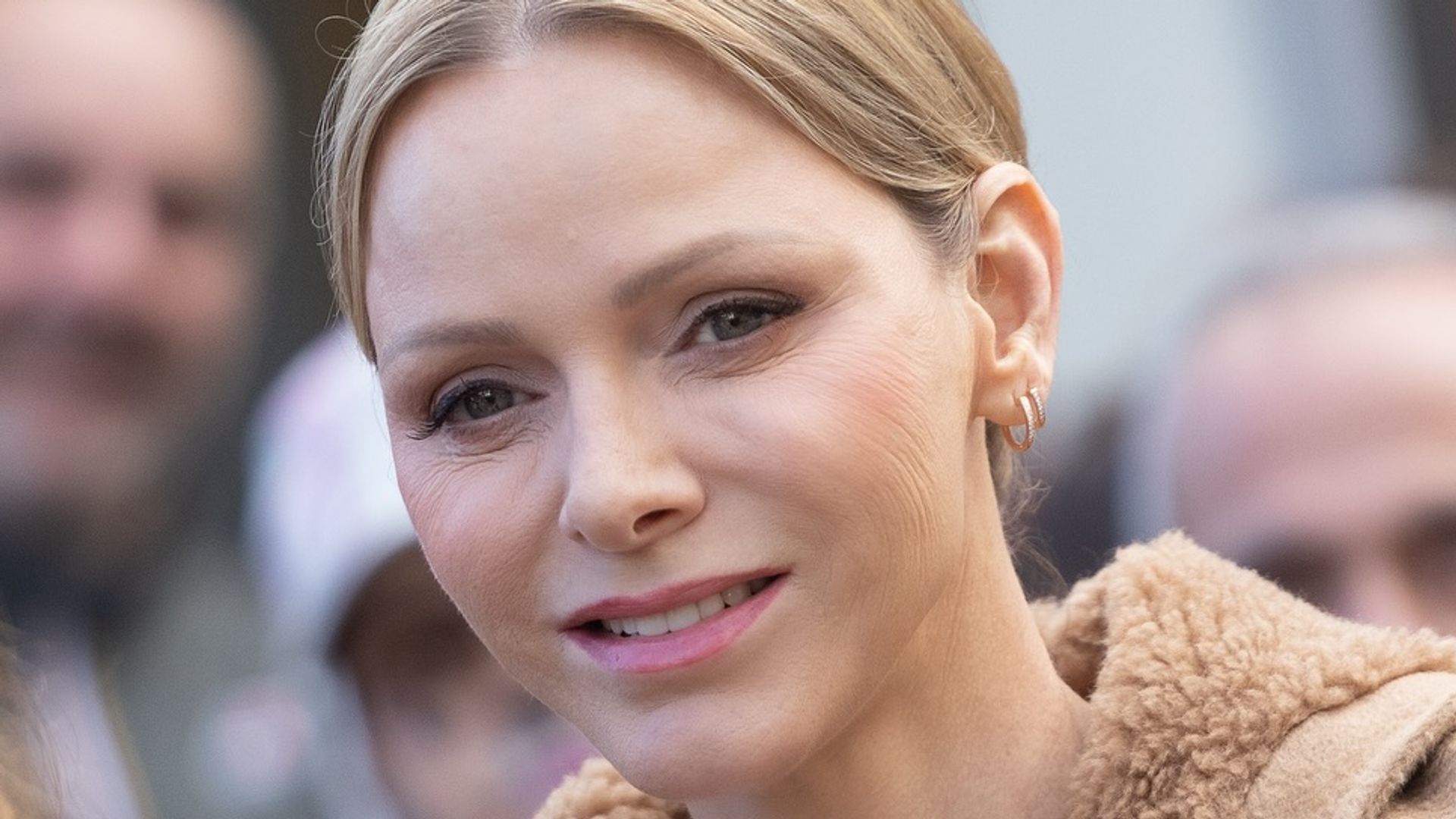 Princess Charlene holding chihuahua in tan coat