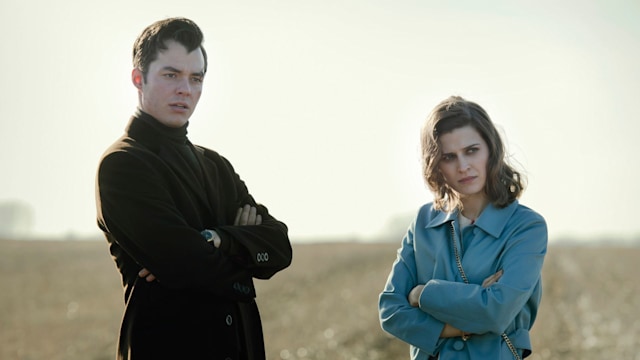 Man and woman standing in field