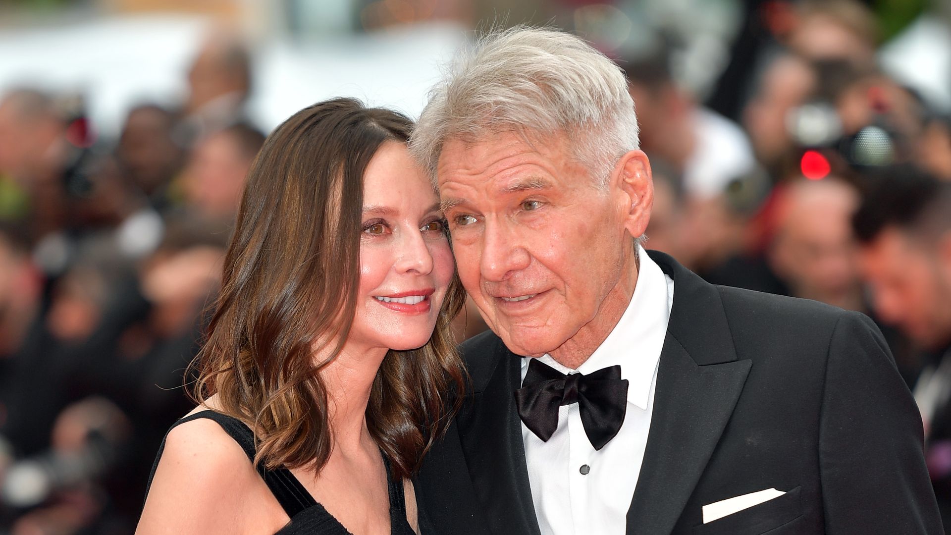 Calista Flockhart and Harrison Ford attend the "Indiana Jones And The Dial Of Destiny" red carpet during the 76th annual Cannes film festival at Palais des Festivals