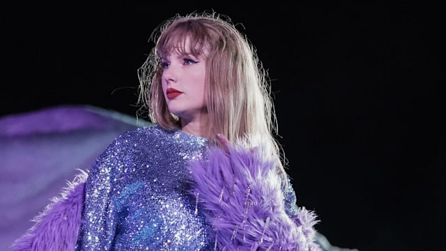 Taylor Swift on stage in purple