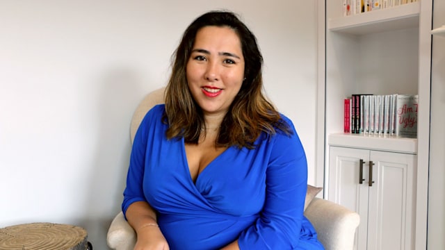 woman in blue sitting on the sofa 