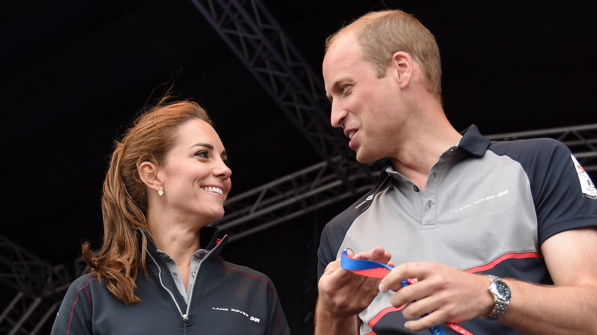 Prince William and Princess Kate smiling at eachother