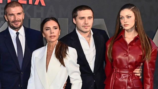 Mia Regan standing with Romeo Beckham, Cruz Beckhan, Harper Beckham, David Beckham, Victoria Beckham, Brooklyn Beckham and Nicola Peltz-Beckham