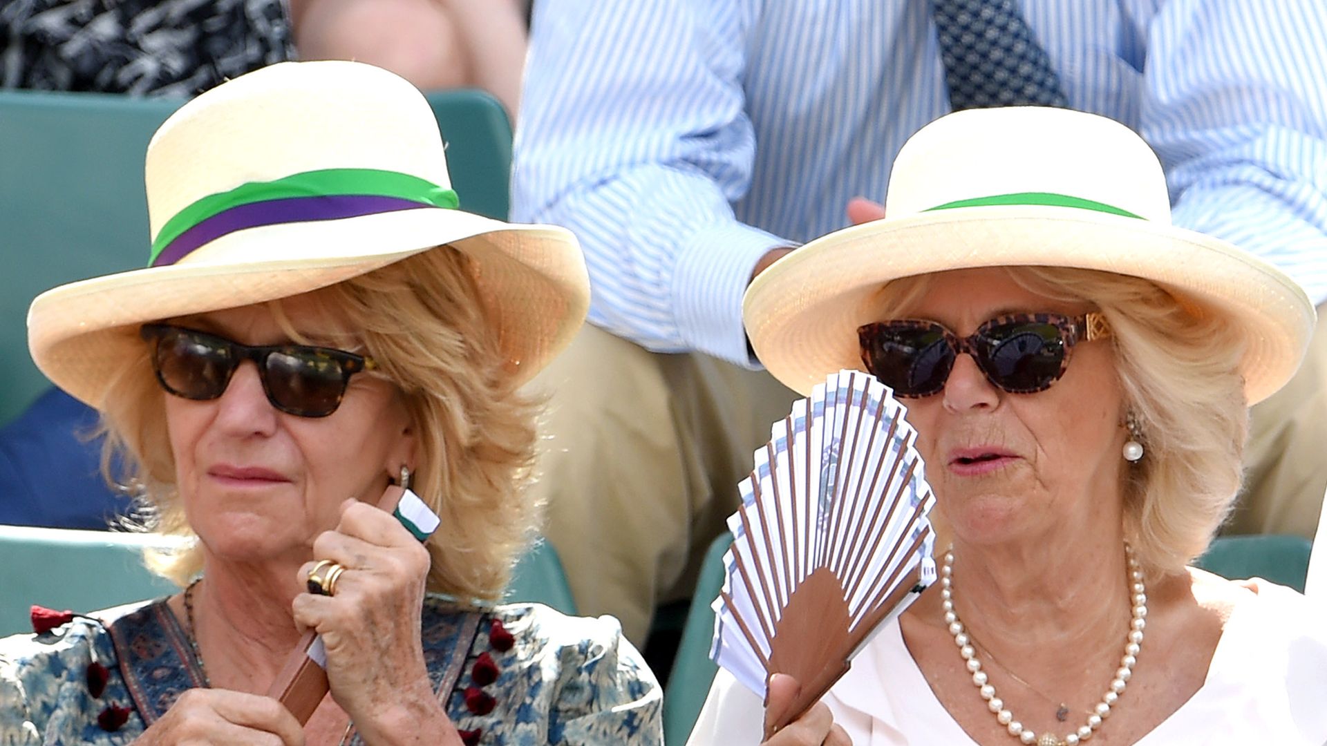 pair of ladies watching tennis match in summer 