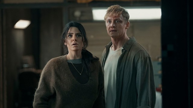 man and woman standing in house