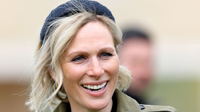 Zara Tindall attends day 2 of the April Meeting at Cheltenham Racecourse 2024 wearing green khaki coat and headband