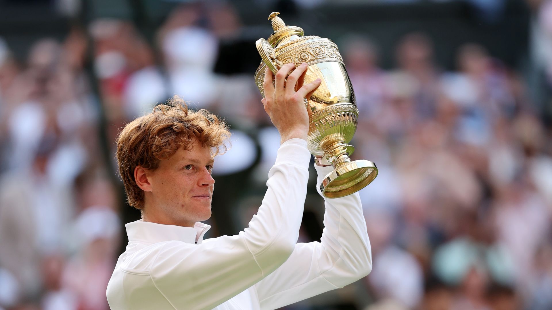 Jannik Sinner of Italy lifts the Gentlemen's Singles Trophy following his victory against Carlos Alcaraz of Spain during the Gentlemen's Singles Final on day fourteen of The Championships Wimbledon 2025 at All England Lawn Tennis and Croquet Club on July 13, 2025 in London, England