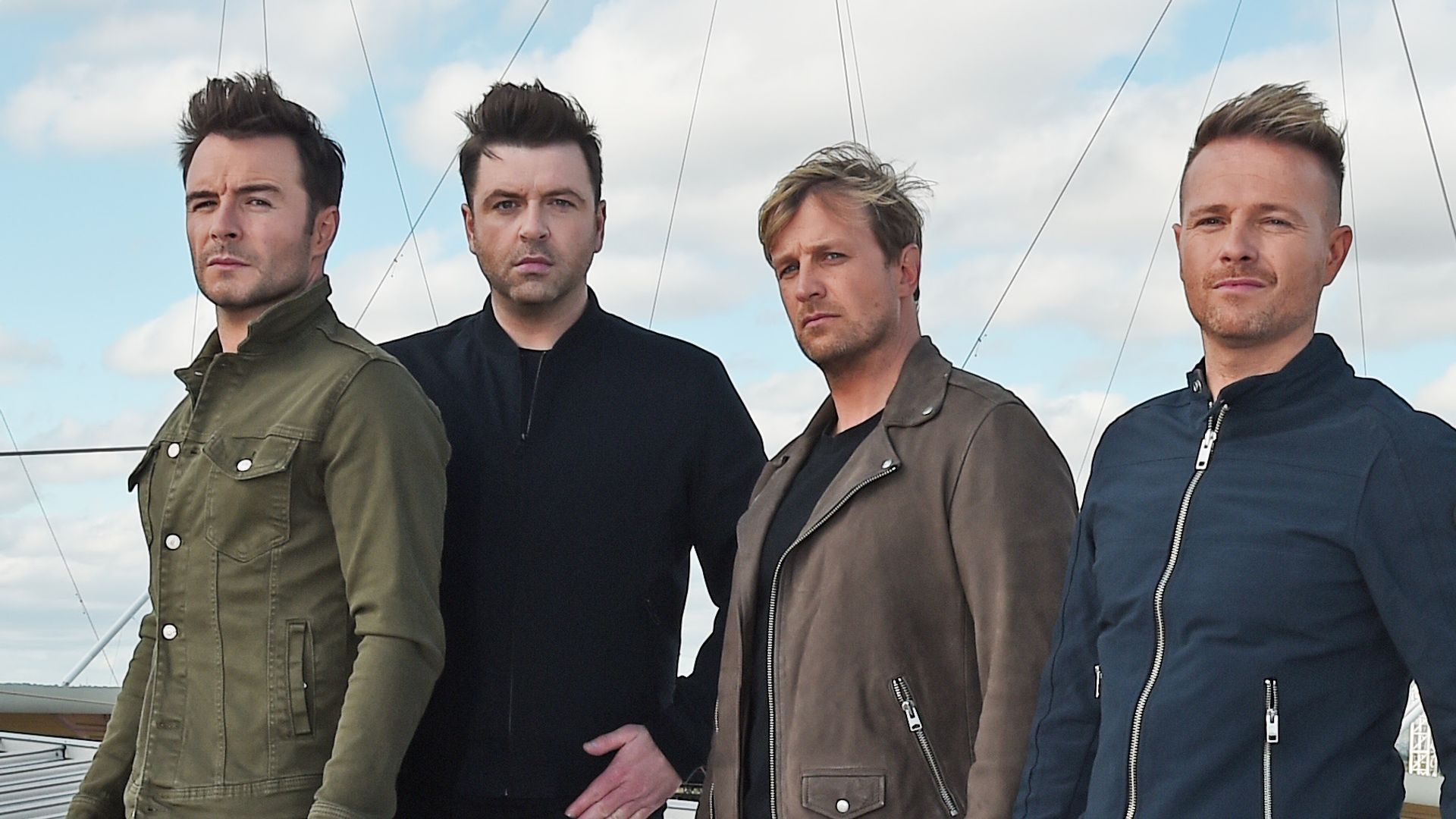 Four members of |Westlife stood on Wembley Arena