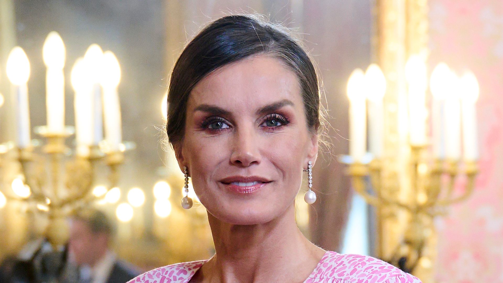 Queen Letizia of Spain with hair slicked back in pink