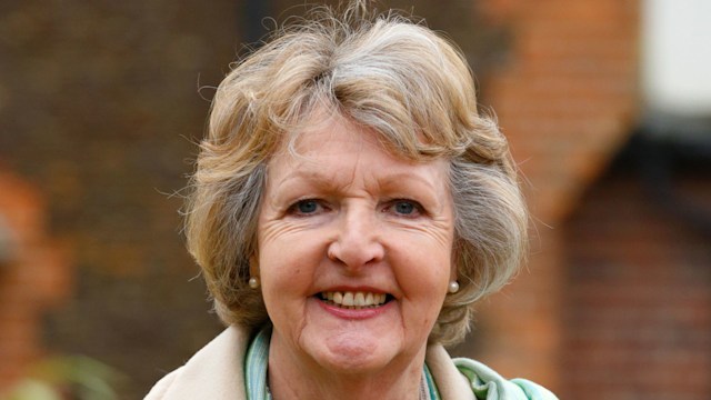 woman standing in beige coat