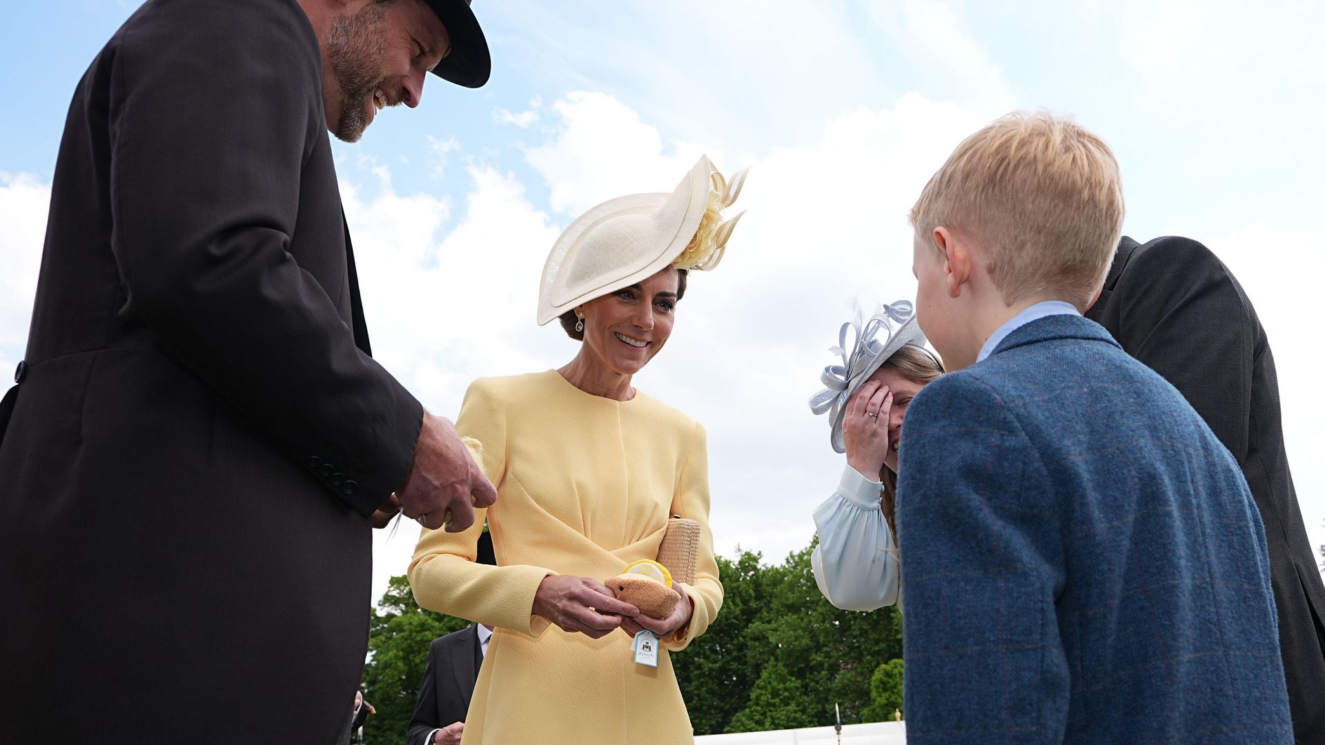 The Prince and Princess of Wales receive Jellycat soft toys and meet the family of Liz Hatton, mother Vicky Robayna, father Aaron and brother Mateo at a Royal Garden Party at Buckingham Palace
