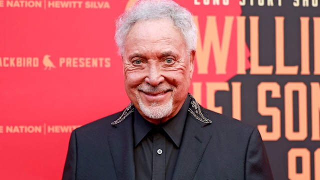 Sir Tom Jones smiling at a red carpet event