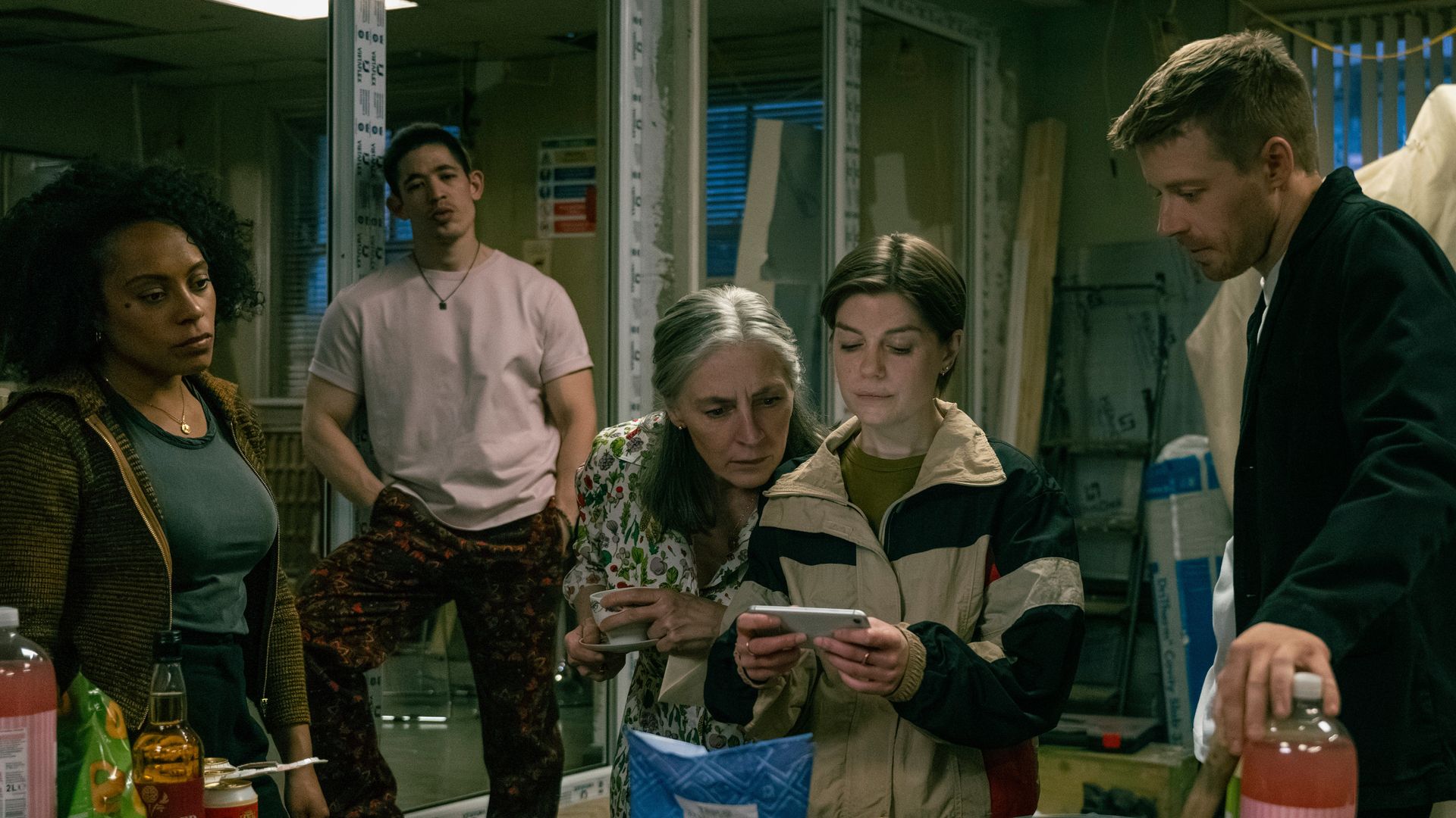 group of people in office looking at phone