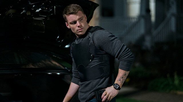 Gabriel Basso stands by car in The Night Agent 