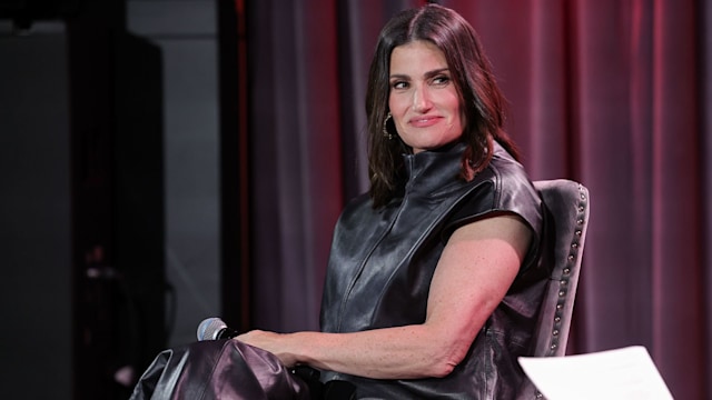 Idina Menzel smiling in an all-leather outfit