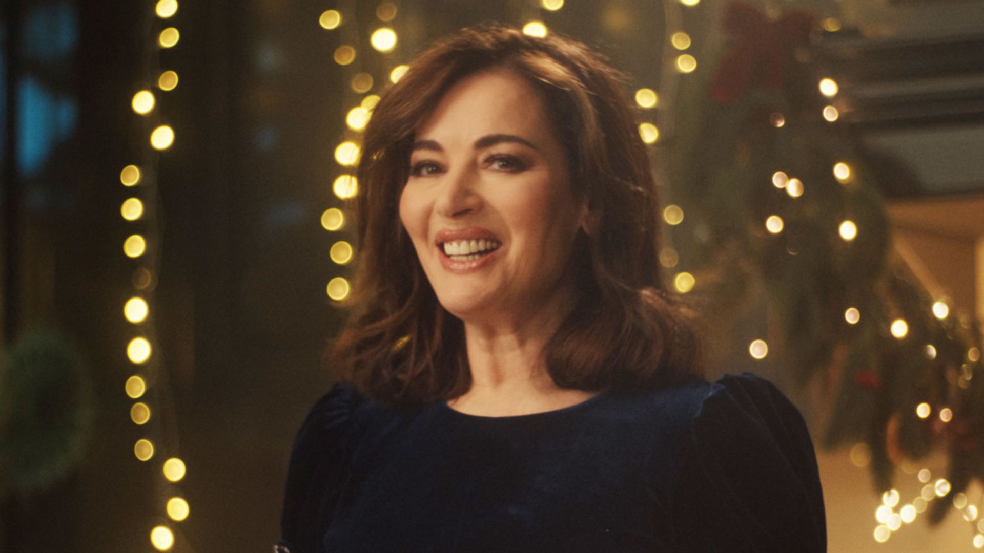 Nigella Lawson smoulders in blue velvet dress as she puts on flirty display in new Christmas campaign