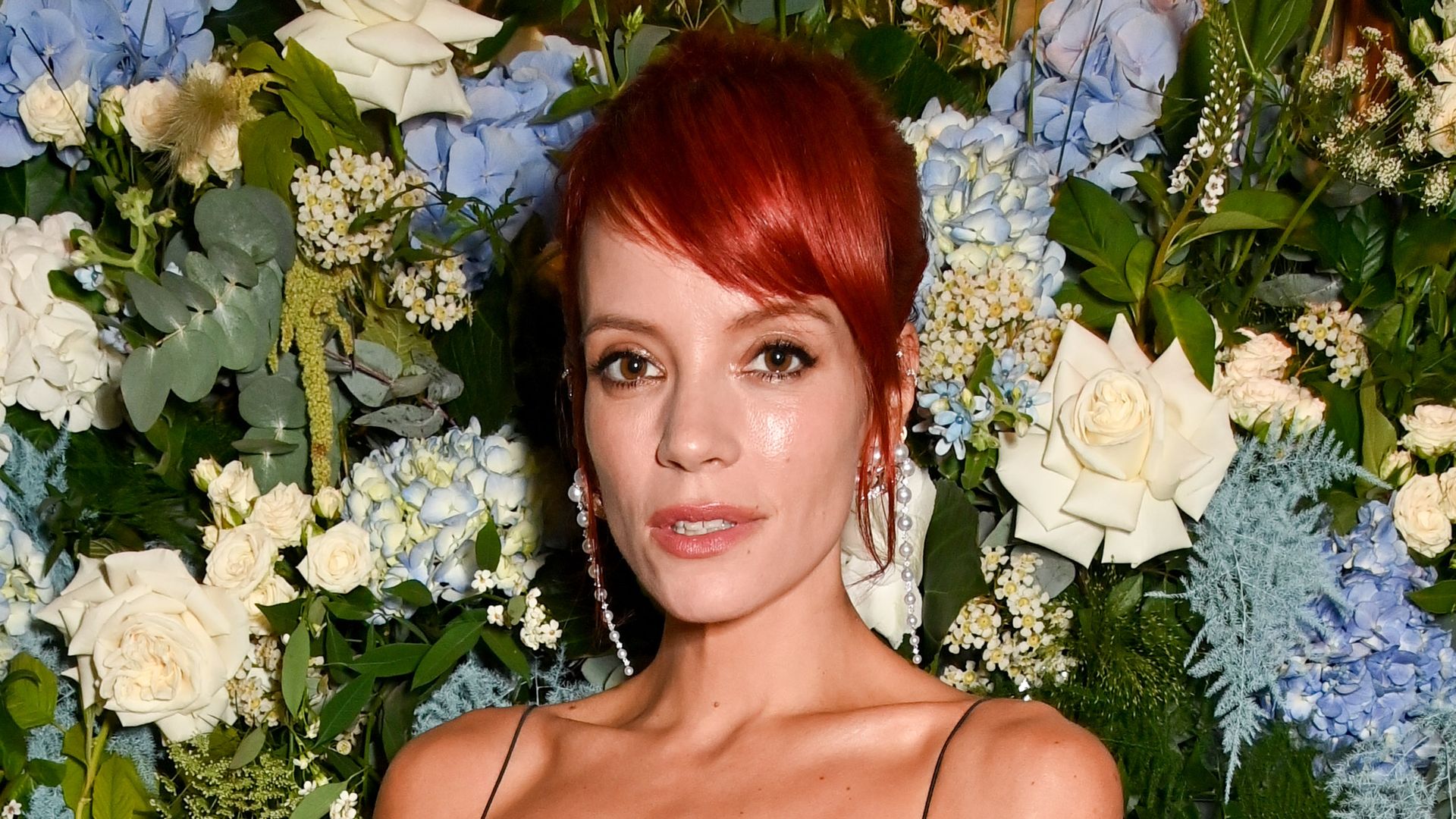 Red-haired Lily Allen smoulders in black off-the-shoulder spaghetti strap dress