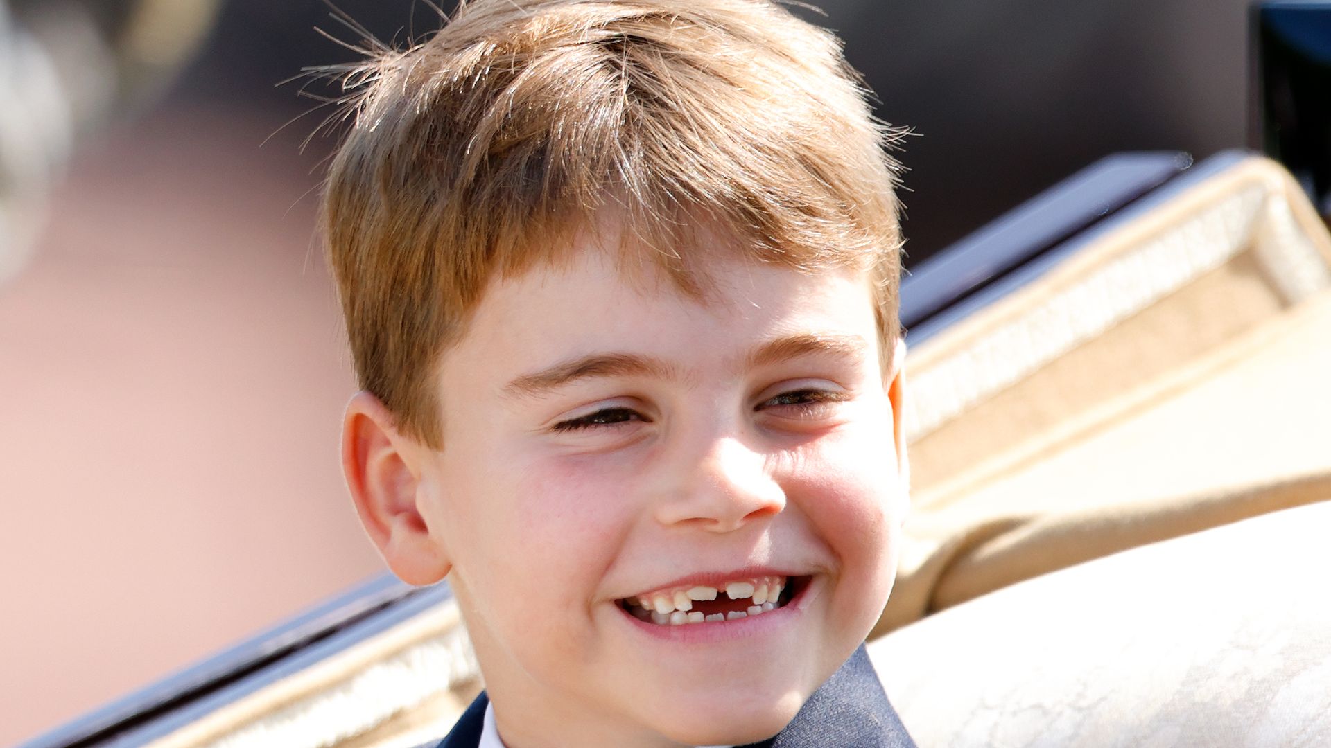 Prince Louis smiling while in a carriage