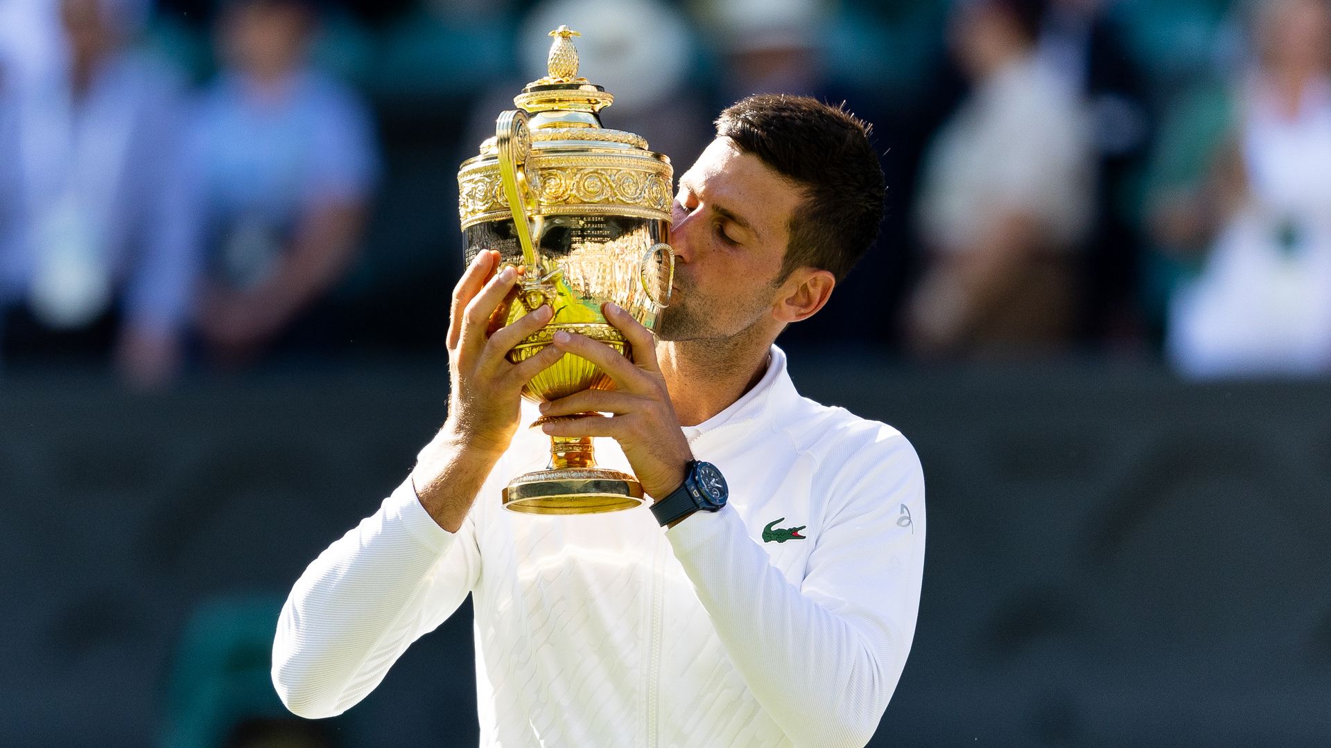 Novak Djokovic kisses the trophy after victory in the Wimbledon Men's Singles Final