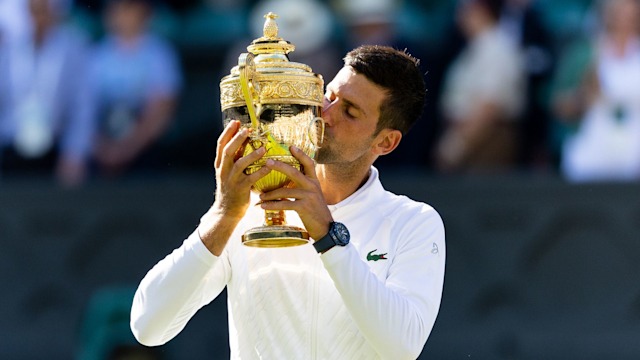 Novak Djokovic kisses the trophy after victory in the Wimbledon Men's Singles Final