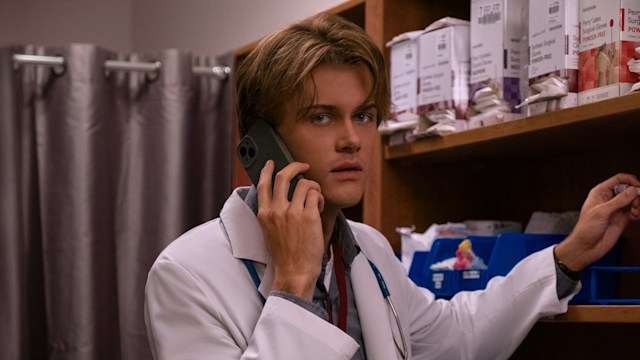 man in white coat on mobile phone