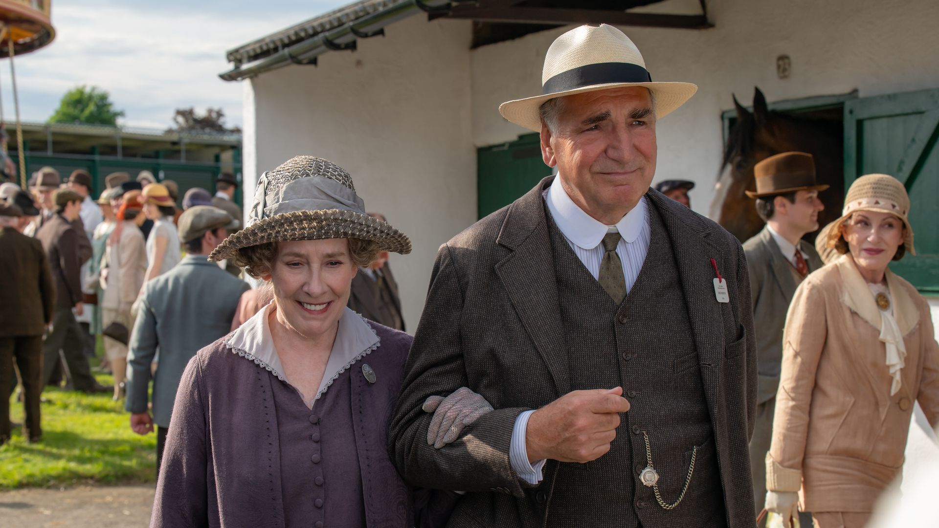 man and woman linking arms walking