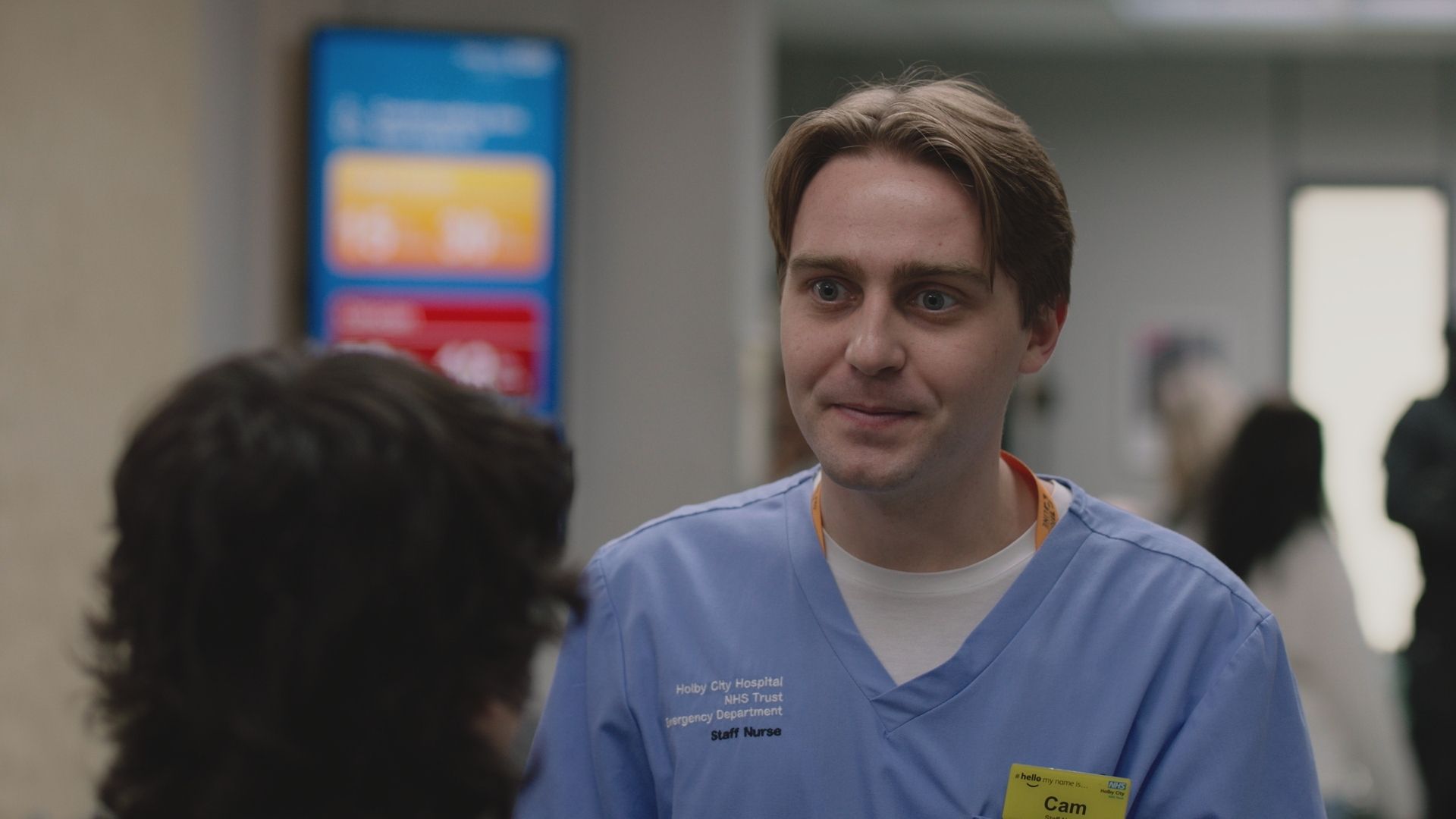 Barney Walsh as Cam Mickelthwaite in Casualty wearinh hospital scrubs