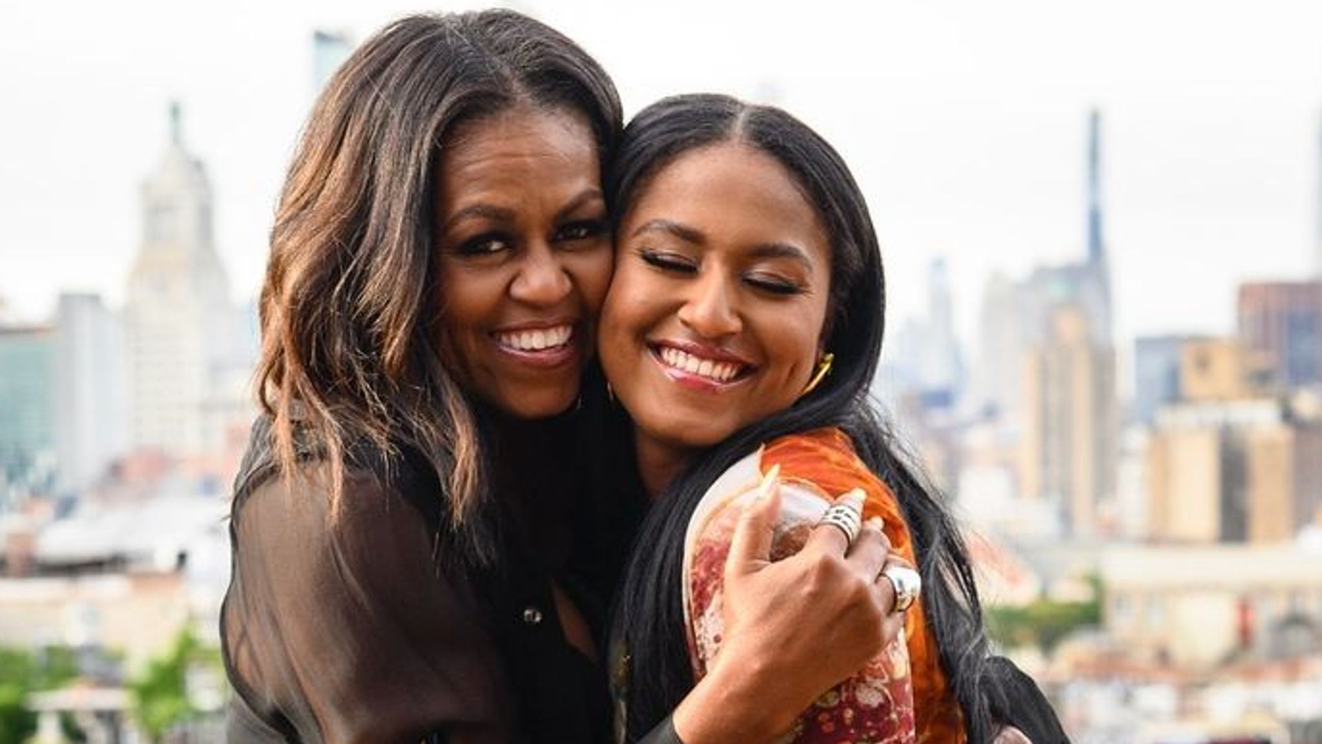Michelle Obama's daughter Sasha, 23, rocks rainbow heels as she poses at rooftop bar with famous mom on bittersweet day
